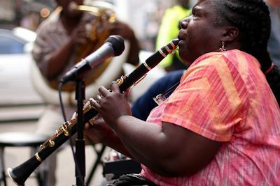 Woman playing clarinet during live performance; rent clarinets here
