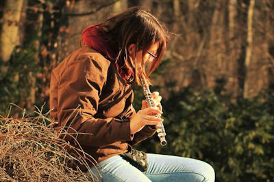 A flute player in the woods; rent flutes here.